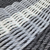Close-up of twisted yarn in various shades of gray and white.