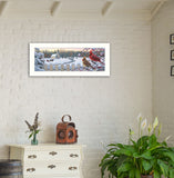 Framed winter scene with birds on a wall above a white cabinet with decorative items.