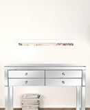 Silver mirrored console table with two drawers against a white wall.