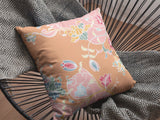 Decorative pillow with floral pattern orange and pink on chair