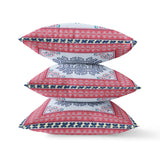 Stack of decorative pillows with pink, blue, and white pattern on a white background