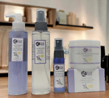 Collection of Lavender Lemon products including a bottle, spray, and jar on a wooden surface.
