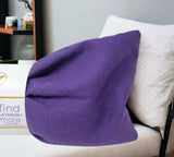 Ultimate Hot & Cold Herbal Neck Pillows - Natural Pain Relief on a white couch with a blurred background