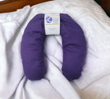 Ultimate Hot & Cold Herbal Neck Pillows - Natural Pain Relief with a label on a white blanket