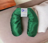 Ultimate Hot & Cold Herbal Neck Pillows - Natural Pain Relief with a label on a beige surface
