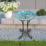 Teal Green Blue White Mosaic Glass Birdbath Bowl with Black Metal Stand on a stand outdoors.
