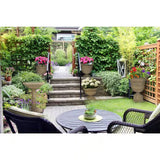 Backyard garden with steps, patio table, chairs, Outdoor Fiberglass Bird Bath and potted plants.