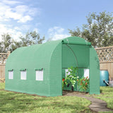 Green inflatable greenhouse with plants inside, set against a blue sky and trees.