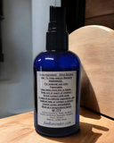 Blue spray bottle with a label on a wooden surface