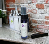Bottle of 'Sexy Man' cologne on a kitchen counter with a brick wall background