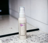 Skincare bottle with a label on a marble surface