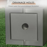 Gray square block with a drainage hole on a grass background