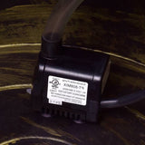 Outdoor 2-Tier Rustic Barrel Water Fountain with Submersible Pump on a dark background