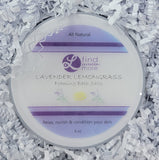Lavender Lemongrass foaming bath salts container on white shredded paper