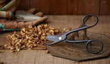 Unique British Black Garden Pruners - Handcrafted | From England (Whiteley & Sons) on a wooden surface with dried plants and gardening tools.