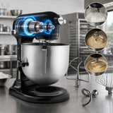 Black and stainless steel stand mixer shown on a kitchen counter with several attachments around it and three circular inset photos showing mixing results. The mixer head is highlighted with glowing blue animation to emphasize power or technology.