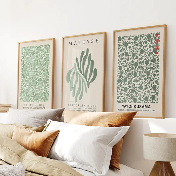 Sage Green Matisse Art Print Set of 3 Piece on a wall above a bed with pillows and a lamp.