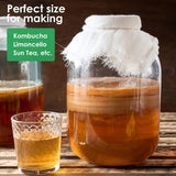 Glass jar with liquid and cloth on a wooden surface, next to a glass of liquid, with text about kombucha and sun tea.