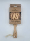 Bamboo hair brush with packaging on a white background