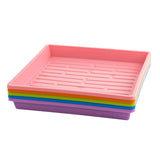 Stack of colorful plastic trays on a white background