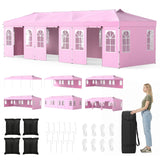 Pink event marquee tent with side wall panels, shown in multiple layout views, with included accessories such as black floor pads, white stakes, ropes, and a black carry bag. A woman stands beside the carry bag on the right.