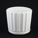 White ribbed ceramic planter on a black background 3-Piece White Ceramic Planter Pot Set with Fluted Design & Saucers
