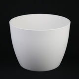 White ceramic planter on a black background 5-Piece White Plastic Planter Pot Set – Modern Round Design