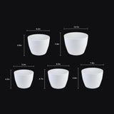 Set of white ceramic pots with dimensions indicated on a black background 5-Piece White Plastic Planter Pot Set – Modern Round Design
