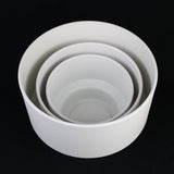Set of three white ceramic bowls of different sizes on a black background 3-Piece White Plastic Planter Pot Set – Modern Pedestal Base
