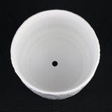 White Stoneware Planter Pot with Embossed Texturea black background