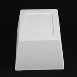 White plastic component with branding on a black background