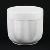 White Stoneware Planter Pot with Vertical Line Texture on a black background