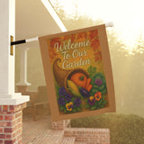 Decorative garden flag with cornucopia, pumpkins, and flowers hanging on a porch.