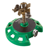 Green and brass sprinkler on a white background