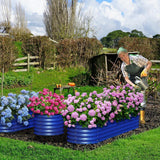 Woman gardening with colorful flower beds in a rural setting