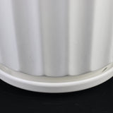 Close-up of a white cylindrical object with ribbed texture on a black background 3-Piece White Ceramic Planter Pot Set with Fluted Design & Saucers