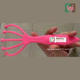 Worm Comb with 'Meme's Worms' branding held by a hand on a tiled floor background