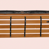 Wooden storage box with black straps on a beige background