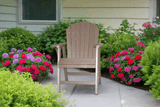 2' Standard Adirondack Chair - In Dining, Counter & Bar Heightson a patio surrounded by flowers and greenery