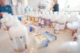Assorted health and wellness products on a counter with people in the background.