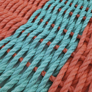 Close-up of turquoise and orange ropes intertwined.
