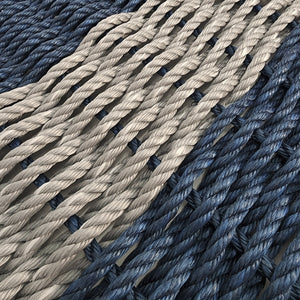 Close-up of blue and beige ropes on a textured surface