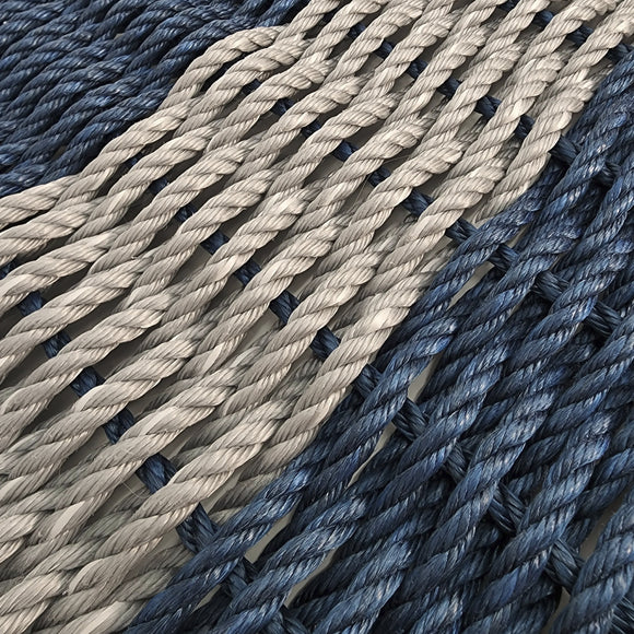Close-up of blue and beige ropes on a textured surface