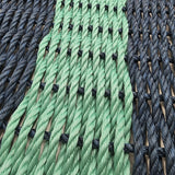 Close-up of green and black rope with a wooden background