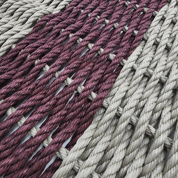 Close-up of woven fabric with alternating pink and gray stripes.