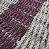 Close-up of woven fabric with alternating pink and gray stripes.