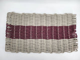 Woven clutch bag with a striped pattern on a white background