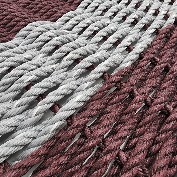 Close-up of braided red and gray ropes.