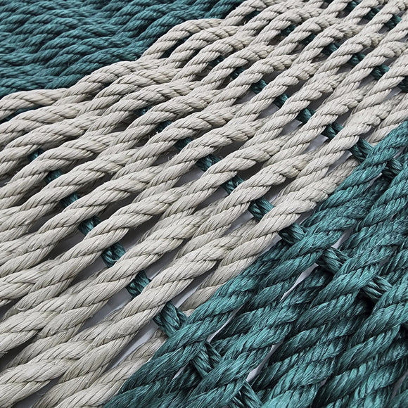 Close-up of teal and beige ropes stacked together