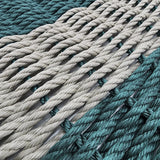 Close-up of teal and beige ropes stacked together